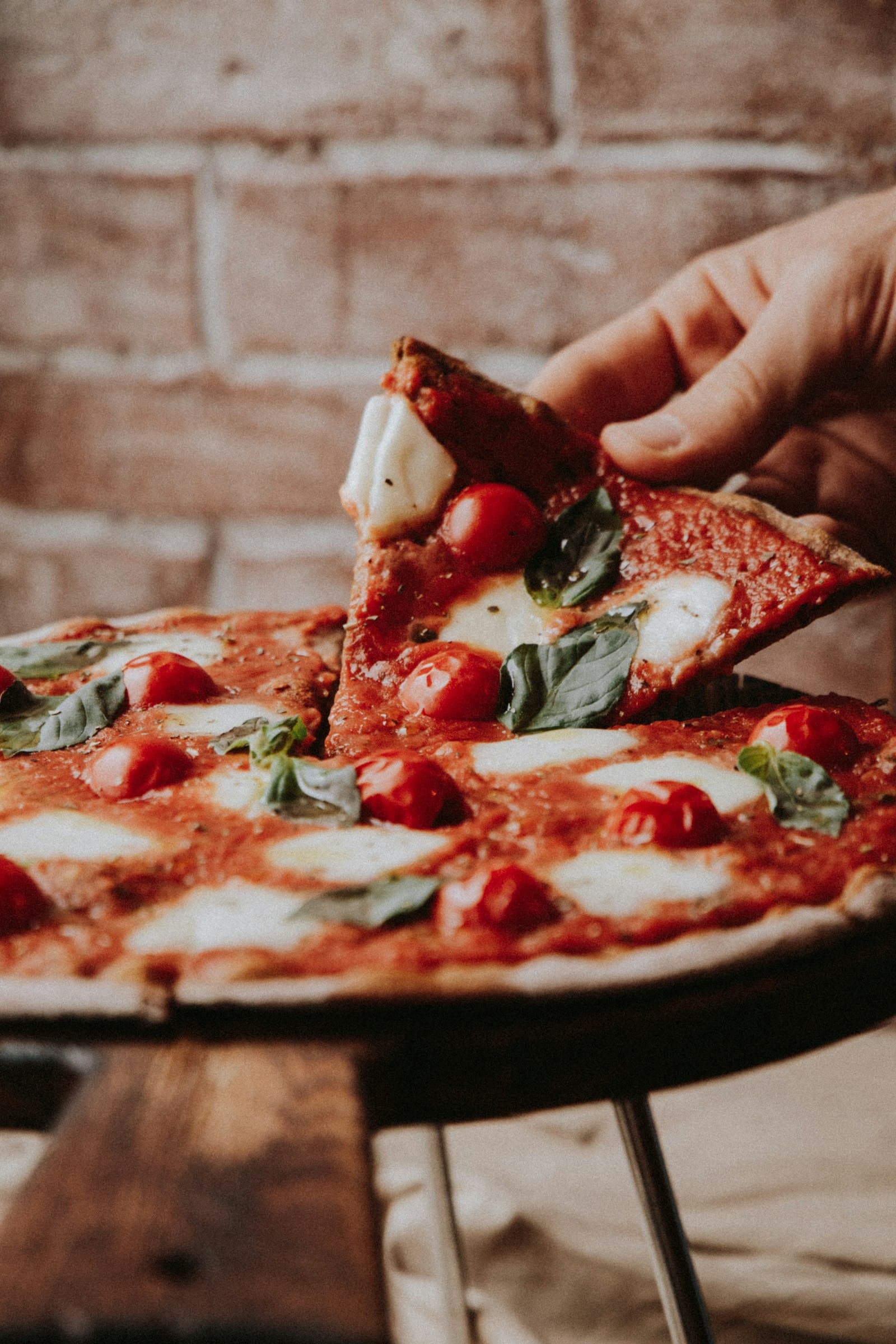 Pizza with mozzarella, cherry tomatoes, and basil